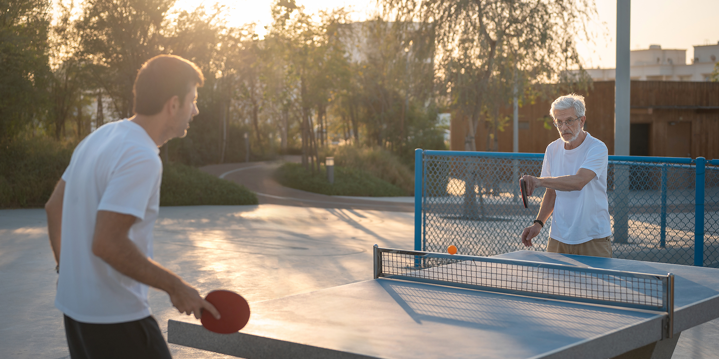 Two people playing outdoor table tennis