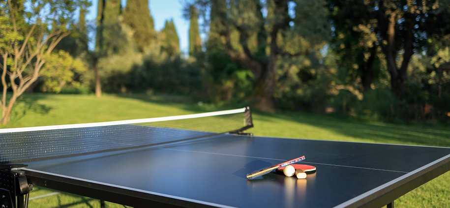 Paddle and balls on table tennis table