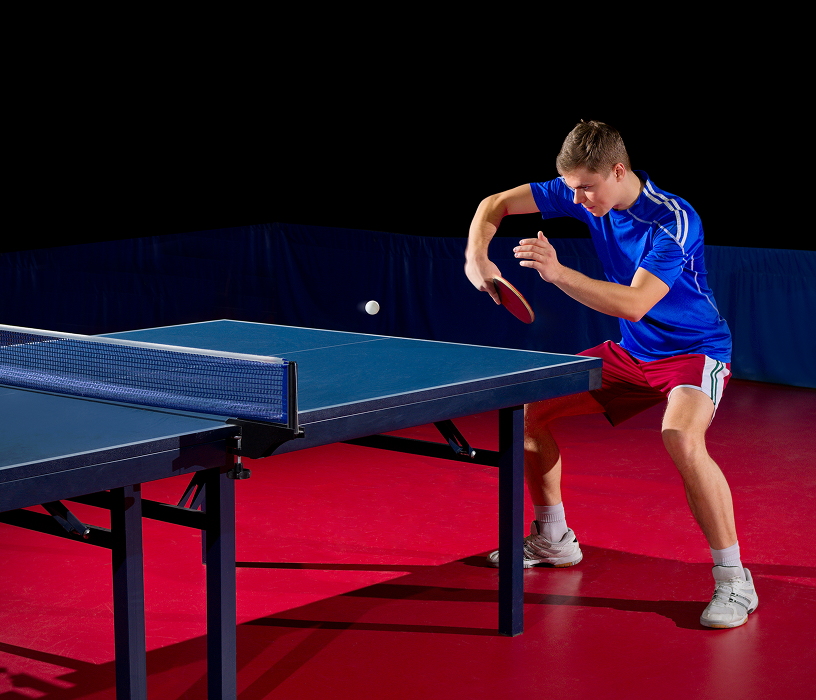 Athlete hitting a ping pong ball