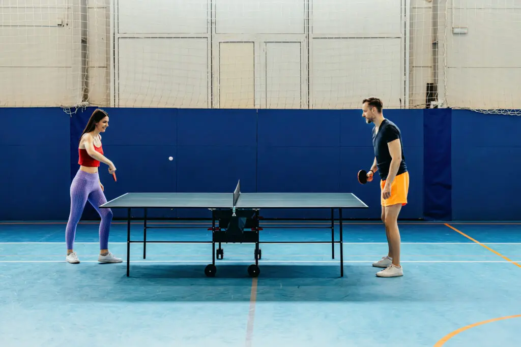 Man and woman engaged in ping pong.
