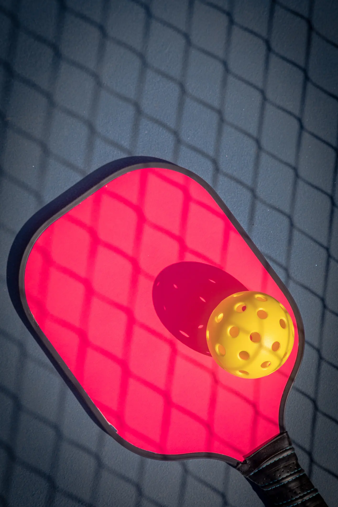Pickleball paddle with yellow ball