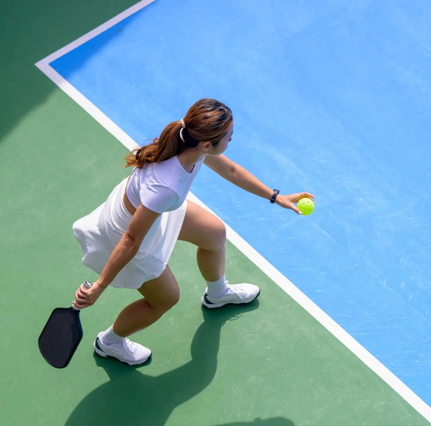 Female athlete with pickleball paddle