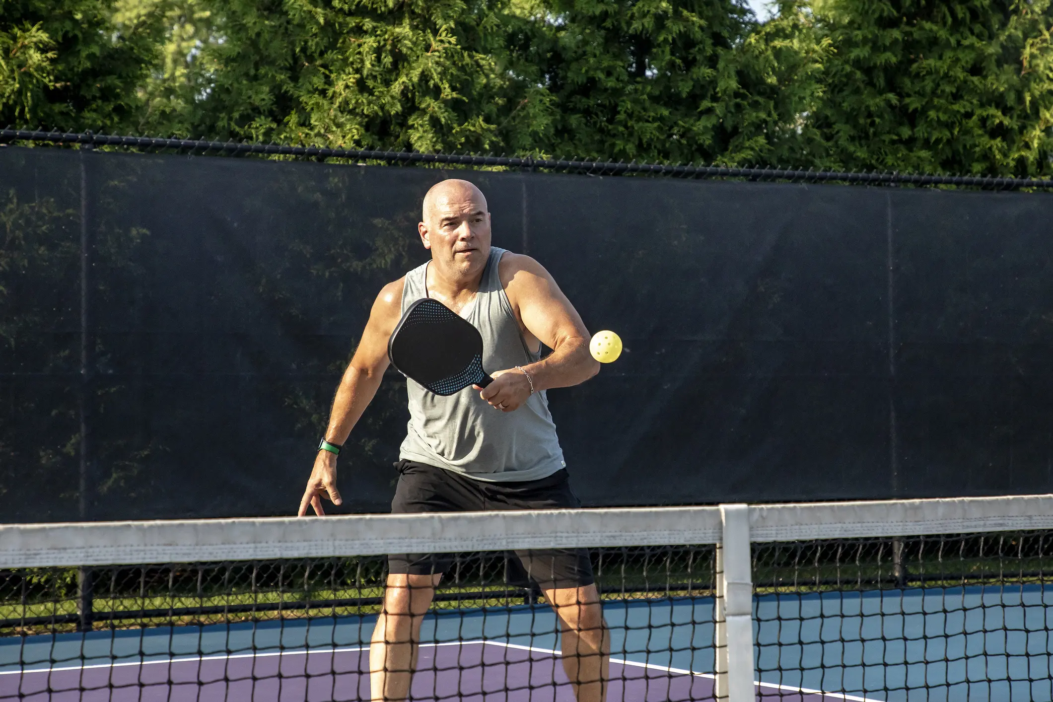 Man playing pickleball outdoors