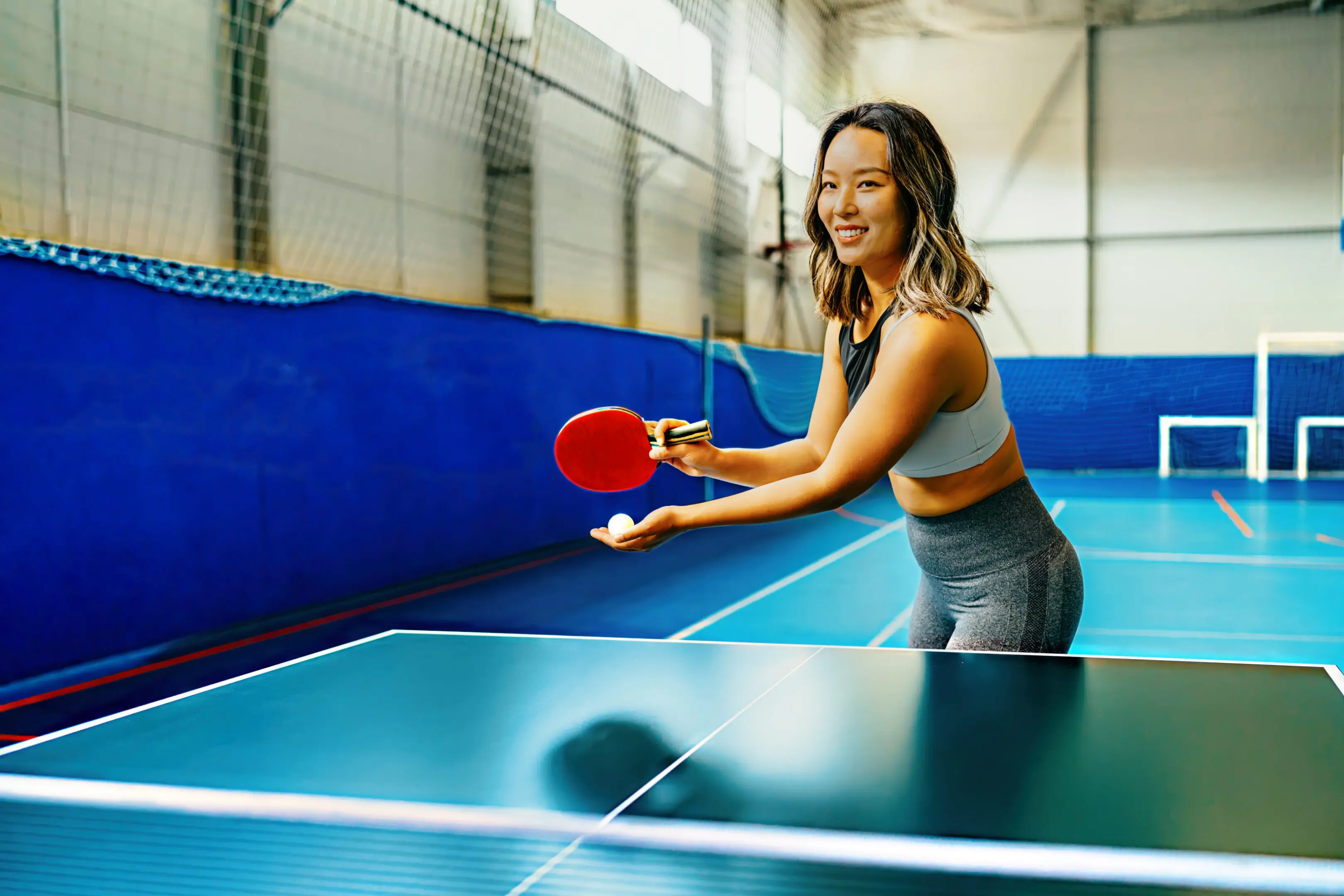 Woman playing table tennis indoors