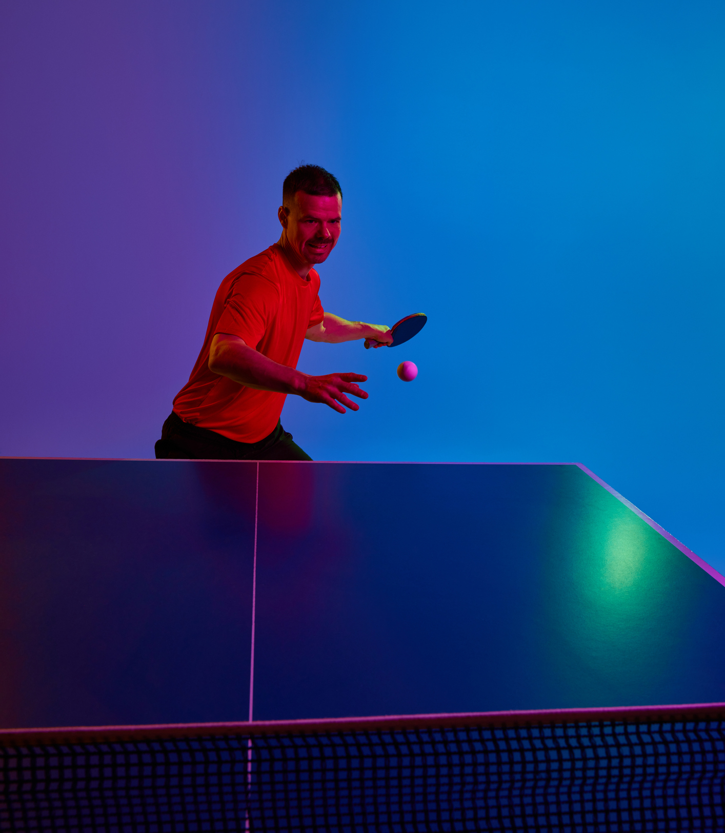 Table tennis action in vibrant lighting