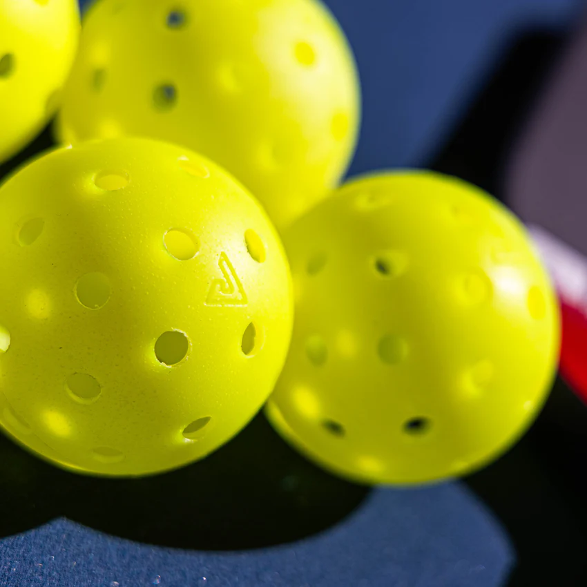 Cluster of perforated yellow balls in sunlight